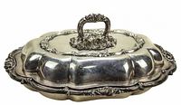 Rectangular lidded serving dish with ornate floral handle and raised base