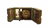 Wooden hinged box opened to display painted eyeball model and wiring on three panels