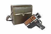 Woodgrain side-panel Super 8 camera alongside brown leatherette carrying case