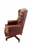 Side view of burgundy leather tufted office chair showing wingback design and wood swivel base