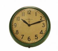 Green-rimmed General Electric wall clock with cream dial and black numerals