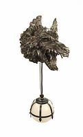 Photo showing the wolf head wall sconce with hanging opaque glass globe, metal cage detail and pull chain, against a white background.