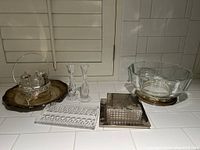 Overview of silver plate and crystal items grouped together on a countertop