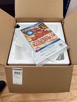 Photo of the box with styrofoam inside and manuals on top