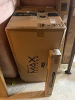 Boxed Bowflex Max Trainer M5 next to boxed Bowflex mat