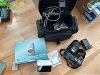 Overall view with Canon PowerShot SD1000 box, Sony DSC-F828 camera, camera bag and charger