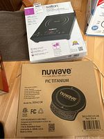 Boxed Salton portable induction cooktop and Nuwave PIC Titanium cooktop side by side