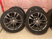 Two of the four assembled wheels leaning against a pink insulated wall.