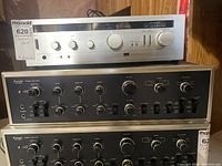 Stacked front view showing one A-5 (silver) and two AU-9500 (black) amplifiers