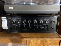 Front view of Sansui AU-999 amplifier with volume, tone controls and MaxSold tag