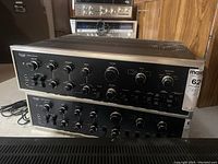 Front view of both stacked amplifiers showing control panels and connected power cord