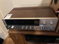 Front view showing tuner scale, Sansui badge, model number