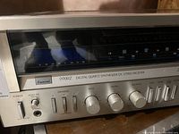 Front view of Sansui 9900Z receiver showing tuning display, control knobs, sliders and power button.