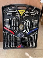 Full view of Maxtech Mechanic 50-piece wrench set in original molded plastic storage case showing organized wrenches with red and blue size band labels and a yellow Maxtech Mechanic logo.