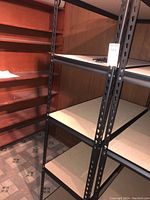 Metal shelving unit with composite wood shelves in a basement setting.