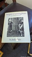 Front cover of 'Imogen Cunningham: A Portrait' hardback book with dust jacket showing black and white photograph of a photographer and a nude woman.
