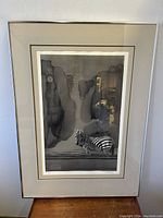 Full view of the framed signed lithograph featuring a zebra with dark abstract rock background under glass with matting.