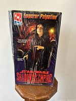 Front view of the box art featuring Emperor Palpatine in black hooded robe, packaging shrink-wrapped