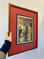 Side angle view showing the wooden frame and holding hand for size reference.