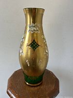 Front side view of vintage Bohemian art glass vase showing floral decoration and gold overlay