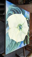 Front cover of the hardcover art book showing large white flower artwork by Georgia O'Keeffe.