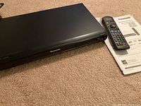 Front angled view of black Panasonic Blu-ray Disc Player showing brand name on front panel.