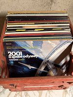 Photo showing a crate of approximately 30 soundtrack records, prominently featuring the 2001: A Space Odyssey soundtrack with space station artwork on front.