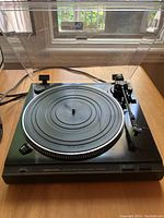 Front view of the Realistic LAB-450 turntable showing platter with rubber mat and tonearm with dust cover open.