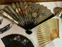 Fans and sunglasses displayed on table showing condition and design