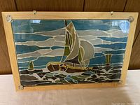 Frontal view of stained glass panel showing sailboat on water with cloudy sky, without hanging chain.
