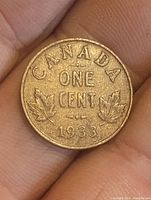 Reverse side of the 1933 Canadian penny with denomination, country, year, and maple leaves.