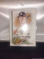 Front side of the 2022 Topps Allen & Ginter Aaron Judge baseball card showing the illustration of Aaron Judge in Yankees uniform, holding a bat, with card branding and player details.