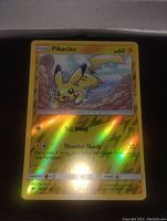 Reverse Holo Pikachu Pokémon card placed on black surface, showing full front artwork and card details.