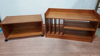 Two teak storage units side by side, left on casters, right with record dividers
