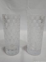 Pair of Tiffany & Co. crystal cylinder vases showing both side-by-side with basket weave textured pattern