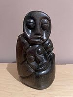 Front view showing both stylized faces and overall form