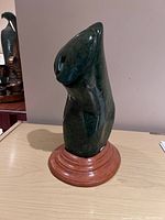 Front view of verdite stone sculpture on wood base