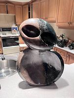 Stacked view of two-piece abstract stone sculpture on kitchen counter