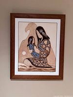 Framed painting displayed on a wall with clear view of the artwork and signature.