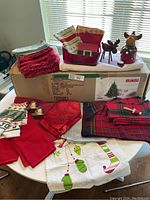 Boxed 4.5-foot Style faux pine Christmas tree with assorted Christmas linens and two reindeer figurines