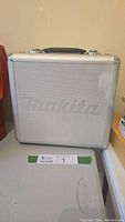 Silver aluminum Makita branded case closed on table