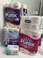 Shot showing multiple packs of toilet paper - Purex Ultra, Royale Velour, Great Value Soft & Strong, and a box of MedSup Canada protective face masks.
