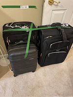 Photo showing all three luggage pieces: one hard-sided suitcase and two soft-sided suitcases side by side on carpet.