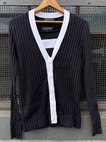 Front view of navy blue ribbed cardigan with white collar and button placket, size medium