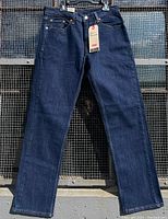 Full front view of men's Levi's 505 dark wash jeans showing straight leg and classic 5-pocket styling.