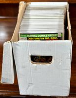 Front view of white comic storage box filled with sleeved comics
