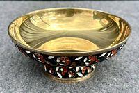 Front view of bowl on pedestal showing gilt interior and black enamel floral band around outer rim