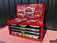 Front view showing chest with lid open and tools inside