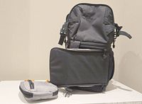 Front view of backpack and accessory pouch on table
