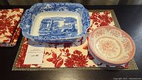 Overall display of Spode casserole dish, Wood and Sons cereal bowls, and floral placemats.